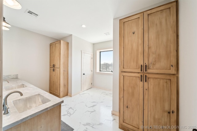 full bath with double vanity, visible vents, a sink, and marble finish floor
