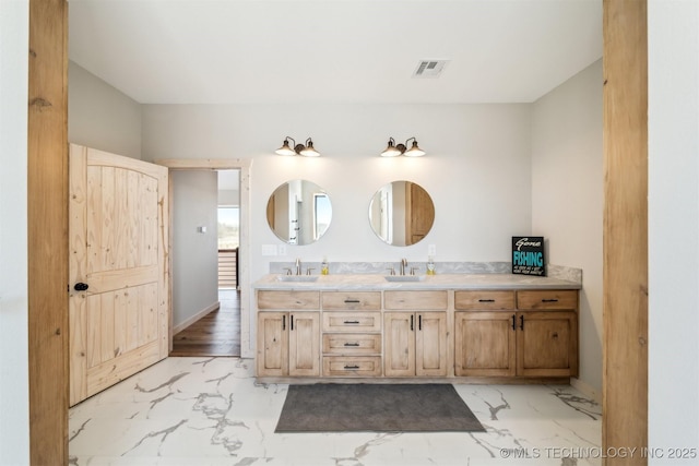 9501 S 4170th Rd, Claremore, OK 74017 - bathroom featuring double vanity, marble look tile flooring, and baseboards