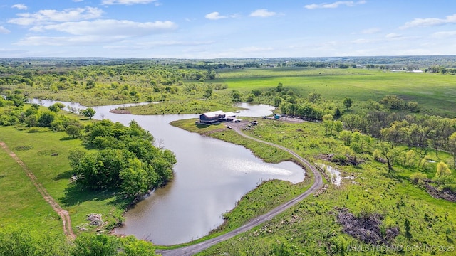 aerial view with a water view and a wooded view