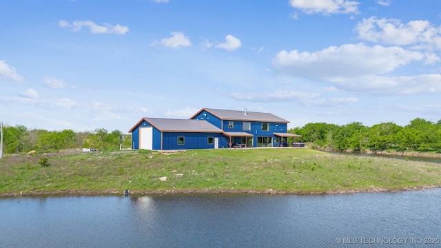 9501 S 4170th Rd, Claremore, OK 74017 - rear view of house with a water view, a garage, and a yard