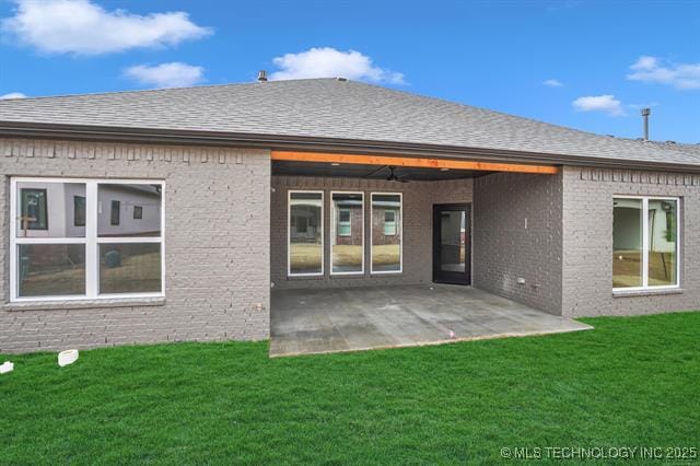 1105 W 86th St, Tulsa, OK 74132 - rear view of property with a yard, brick siding, a patio area, and a shingled roof