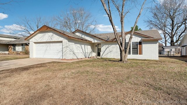 view of property exterior featuring a garage, a yard, brick siding, and driveway