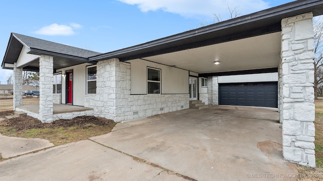 view of front of house with a garage and a carport