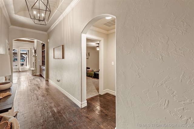 hall with ornamental molding, hardwood / wood-style floors, and built in features