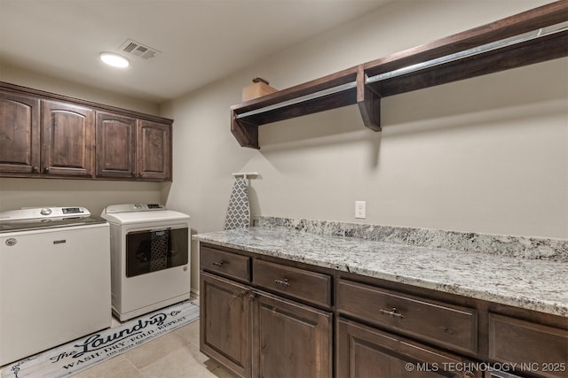 washroom with cabinets and washer and clothes dryer