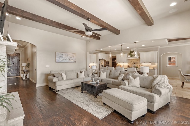 living room featuring beamed ceiling, ceiling fan, and dark hardwood / wood-style flooring