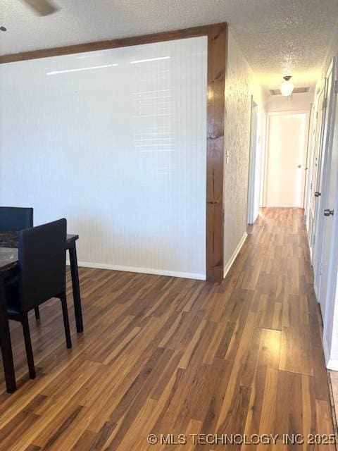 interior space with dark wood-type flooring and a textured ceiling