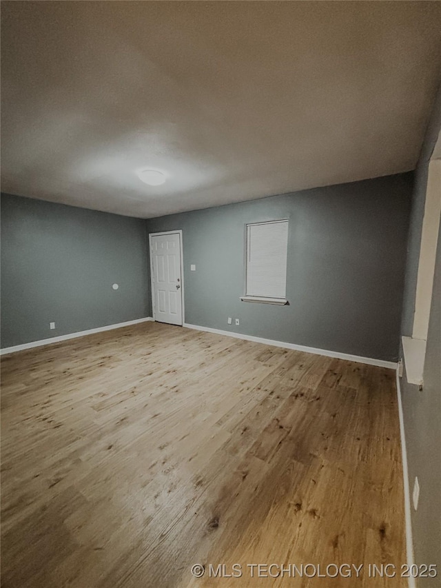 spare room with light hardwood / wood-style flooring