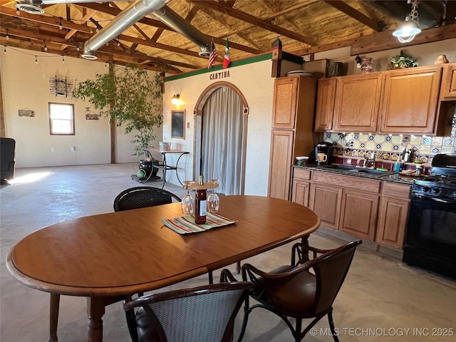 kitchen featuring sink, black gas range, beam ceiling, and wooden ceiling