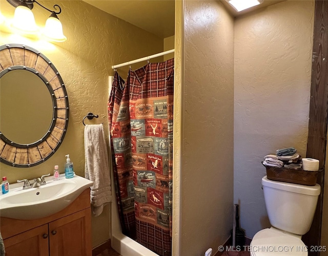 bathroom with vanity, toilet, and a shower with shower curtain