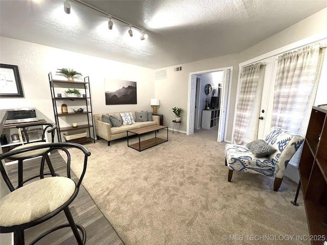 6663 S Victor Ave Unit H # 305, Tulsa, OK 74136 - living area featuring a textured ceiling, french doors, and rail lighting
