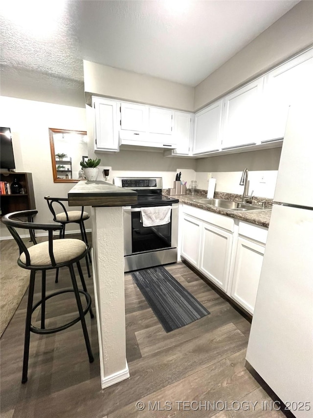 6663 S Victor Ave Unit H # 305, Tulsa, OK 74136 - kitchen featuring stainless steel electric range, freestanding refrigerator, white cabinetry, and dark wood finished floors