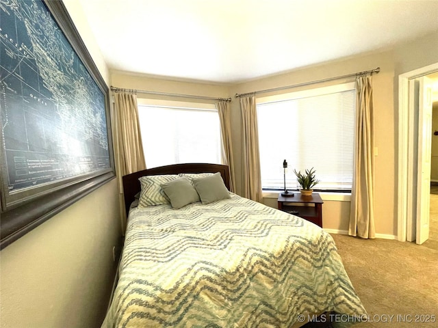 bedroom featuring carpet flooring and baseboards