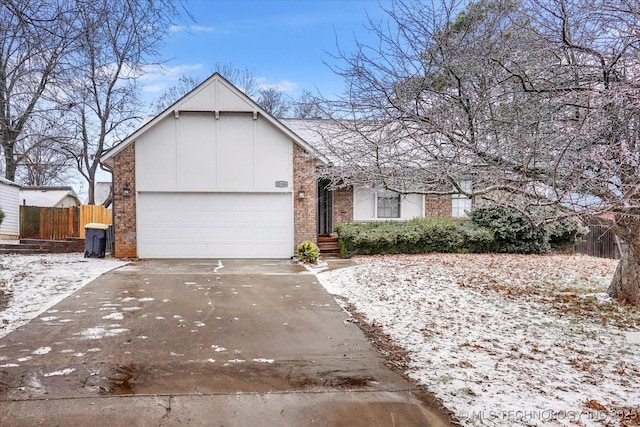 single story home with brick siding, concrete driveway, a garage, and fence