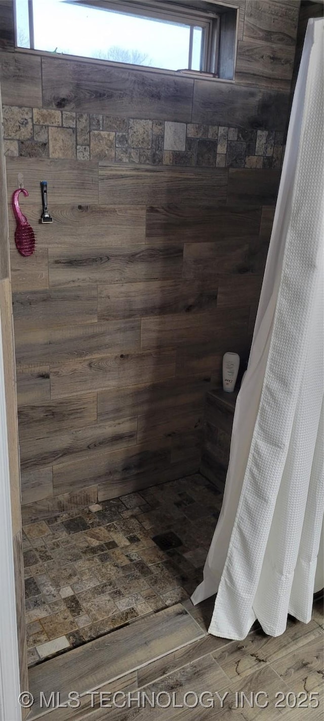 bathroom featuring hardwood / wood-style flooring and curtained shower