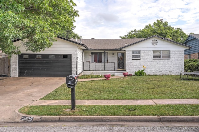 ranch-style house featuring a garage and a front lawn