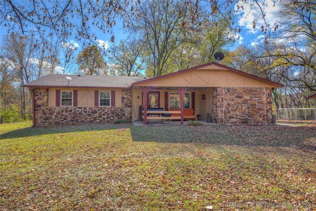 view of front of home featuring a front yard and stone siding