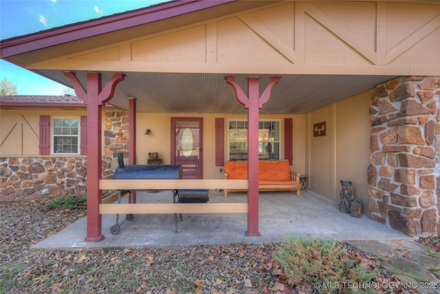 property entrance featuring stone siding and a porch