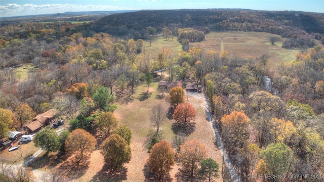 drone / aerial view featuring a view of trees