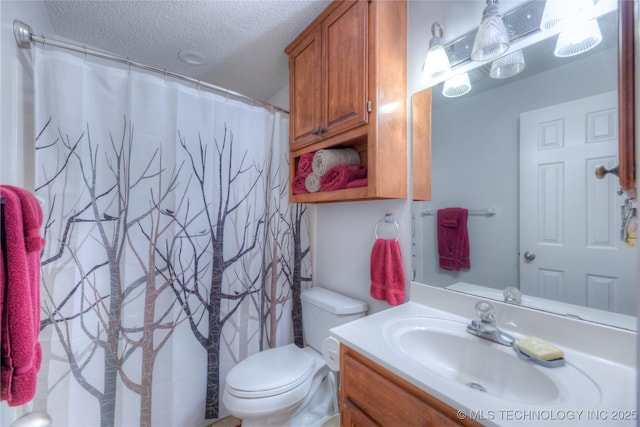 bathroom featuring a textured ceiling, toilet, vanity, and a shower with curtain