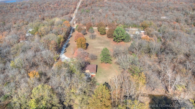 drone / aerial view with a wooded view