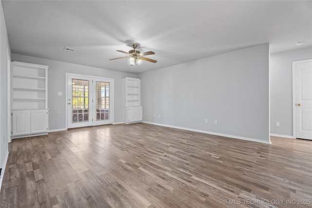 unfurnished living room featuring ceiling fan and light wood-type flooring