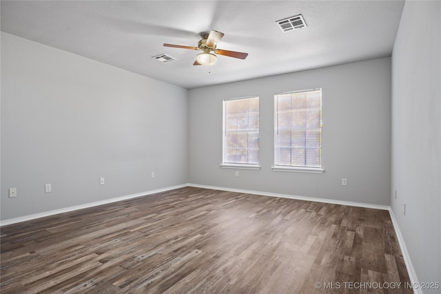 unfurnished room featuring ceiling fan and dark hardwood / wood-style flooring