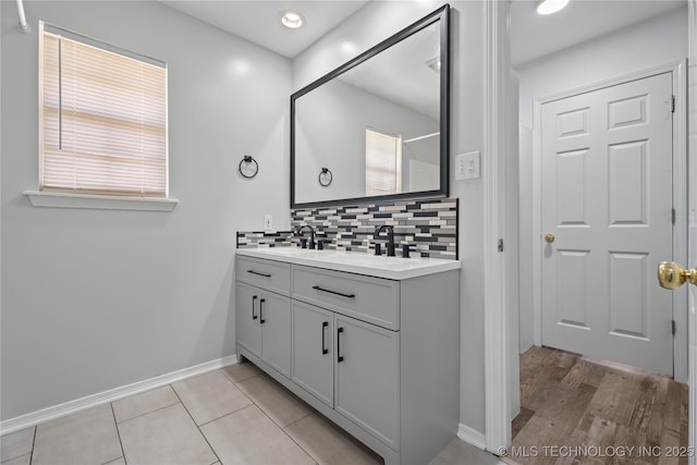 bathroom with tasteful backsplash, vanity, and plenty of natural light