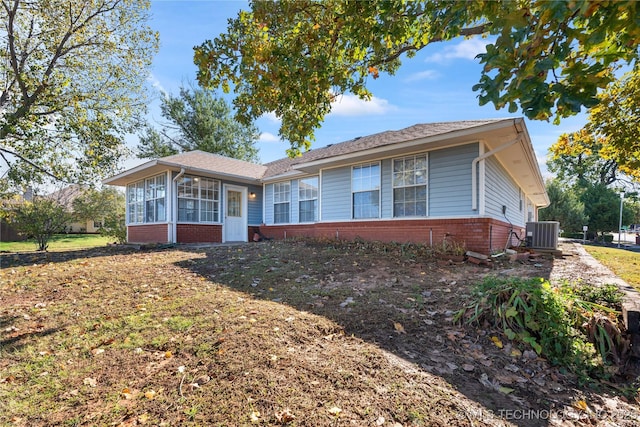 ranch-style home with a sunroom and central air condition unit