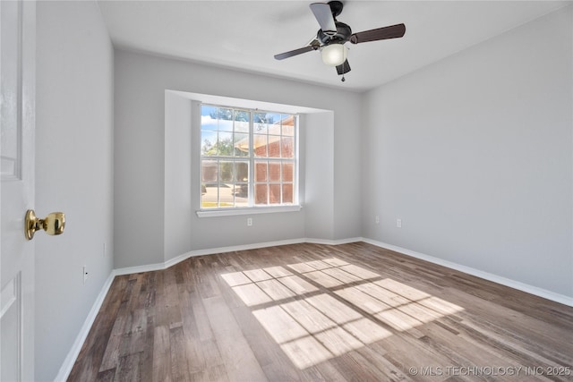 empty room featuring hardwood / wood-style floors and ceiling fan