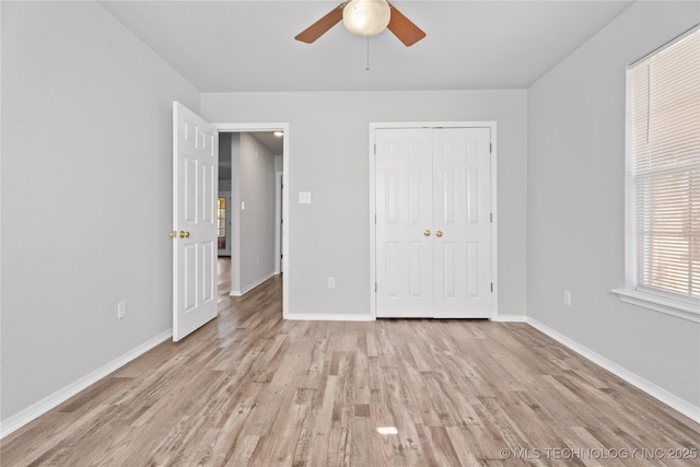 unfurnished bedroom featuring a closet, ceiling fan, and light hardwood / wood-style flooring