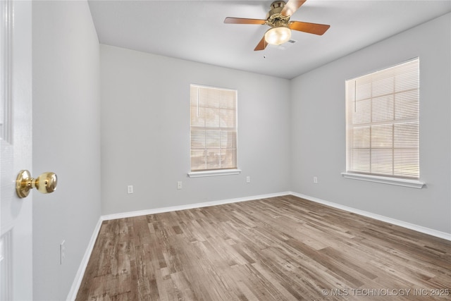 spare room featuring ceiling fan and light hardwood / wood-style flooring