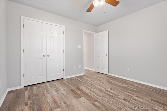 unfurnished bedroom with ceiling fan, light hardwood / wood-style floors, and a closet