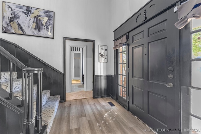 entryway featuring a high ceiling and light wood-type flooring