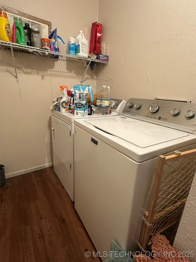 washroom with dark hardwood / wood-style floors and washing machine and clothes dryer