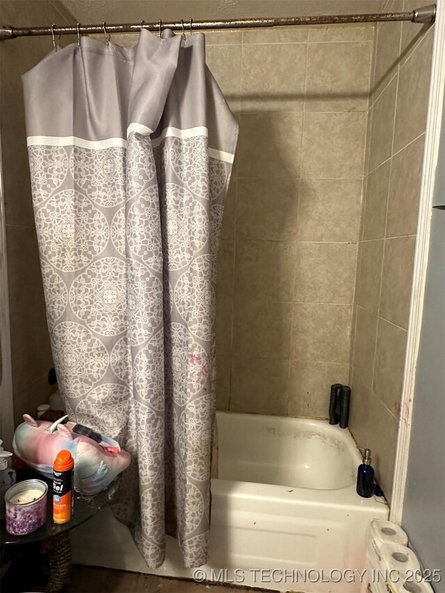 bathroom with shower / bath combination with curtain