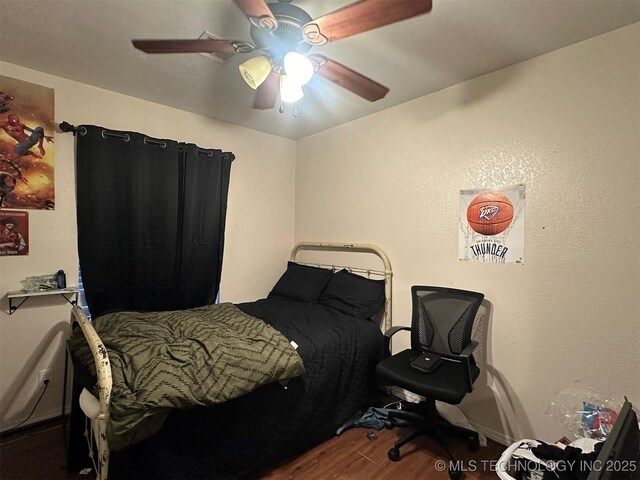 bedroom featuring hardwood / wood-style flooring and ceiling fan