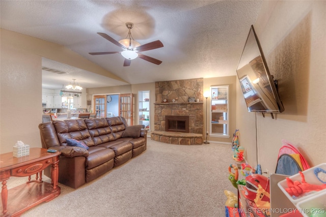 living room with lofted ceiling, a fireplace, carpet floors, a textured ceiling, and ceiling fan with notable chandelier