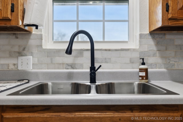 details featuring sink and backsplash