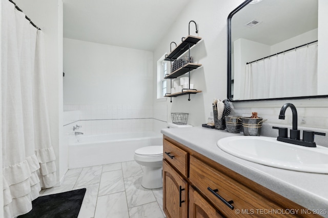 bathroom featuring vanity, toilet, and a washtub