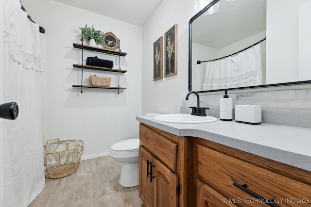 bathroom with vanity, hardwood / wood-style flooring, and toilet