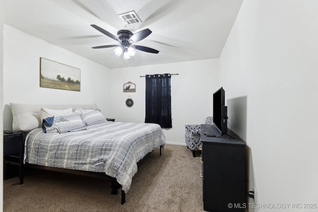 bedroom featuring a textured ceiling, ceiling fan, and carpet