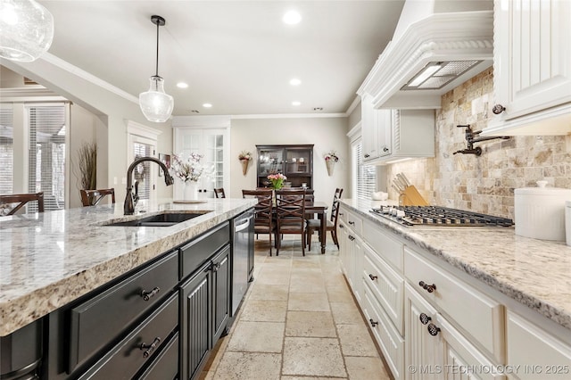 kitchen with custom range hood, sink, and white cabinets