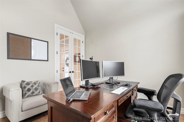 office space with vaulted ceiling, hardwood / wood-style floors, and french doors