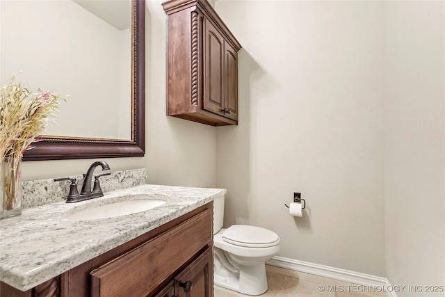 bathroom featuring vanity, tile patterned floors, and toilet