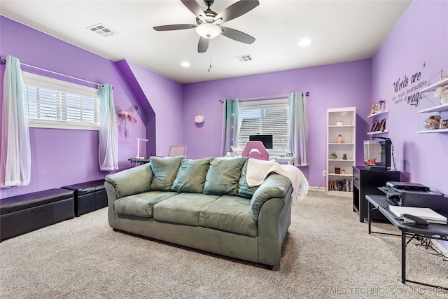 carpeted bedroom featuring multiple windows and ceiling fan