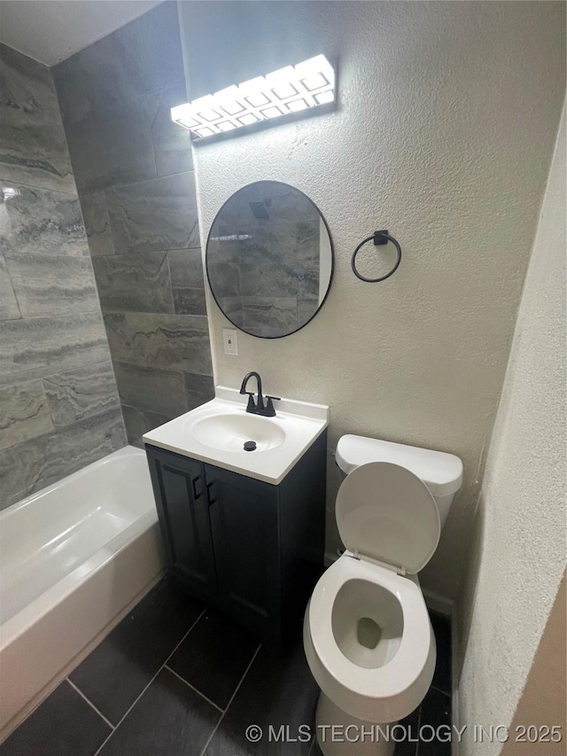 full bathroom with a textured wall, bathtub / shower combination, toilet, vanity, and tile patterned floors