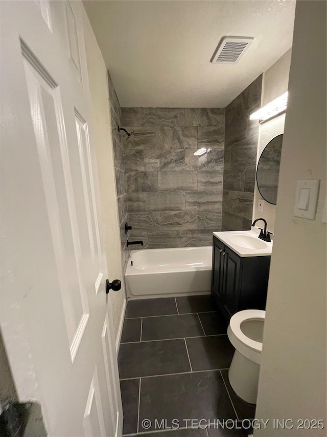 bathroom featuring tile patterned flooring, toilet, vanity, visible vents, and shower / bathing tub combination