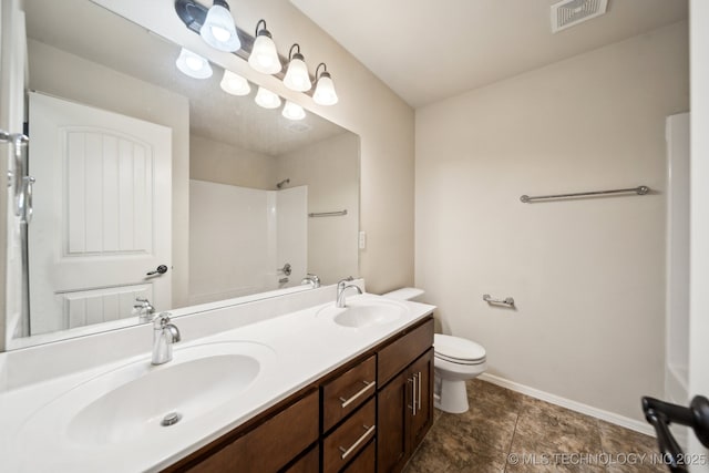 bathroom with toilet, vanity, and walk in shower