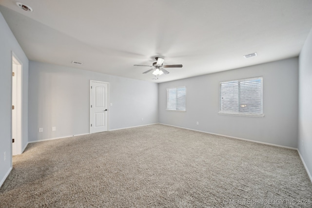 empty room with ceiling fan and carpet floors